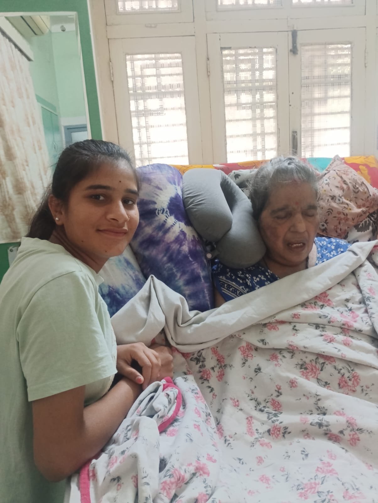 Caregiver assisting an elderly patient at home