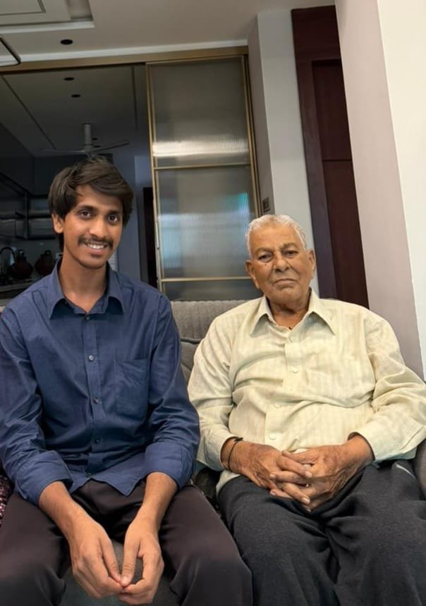 Caregiver sitting with elderly family members at home