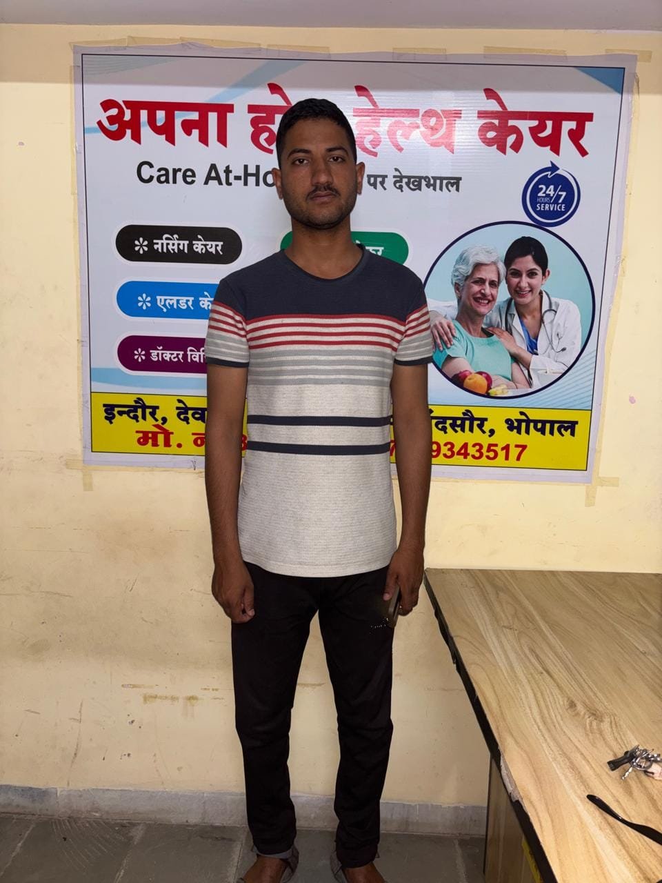 Apna Home Health Care staff member with company poster